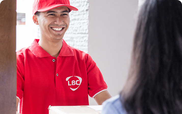 LBC delivery man handing package to customer