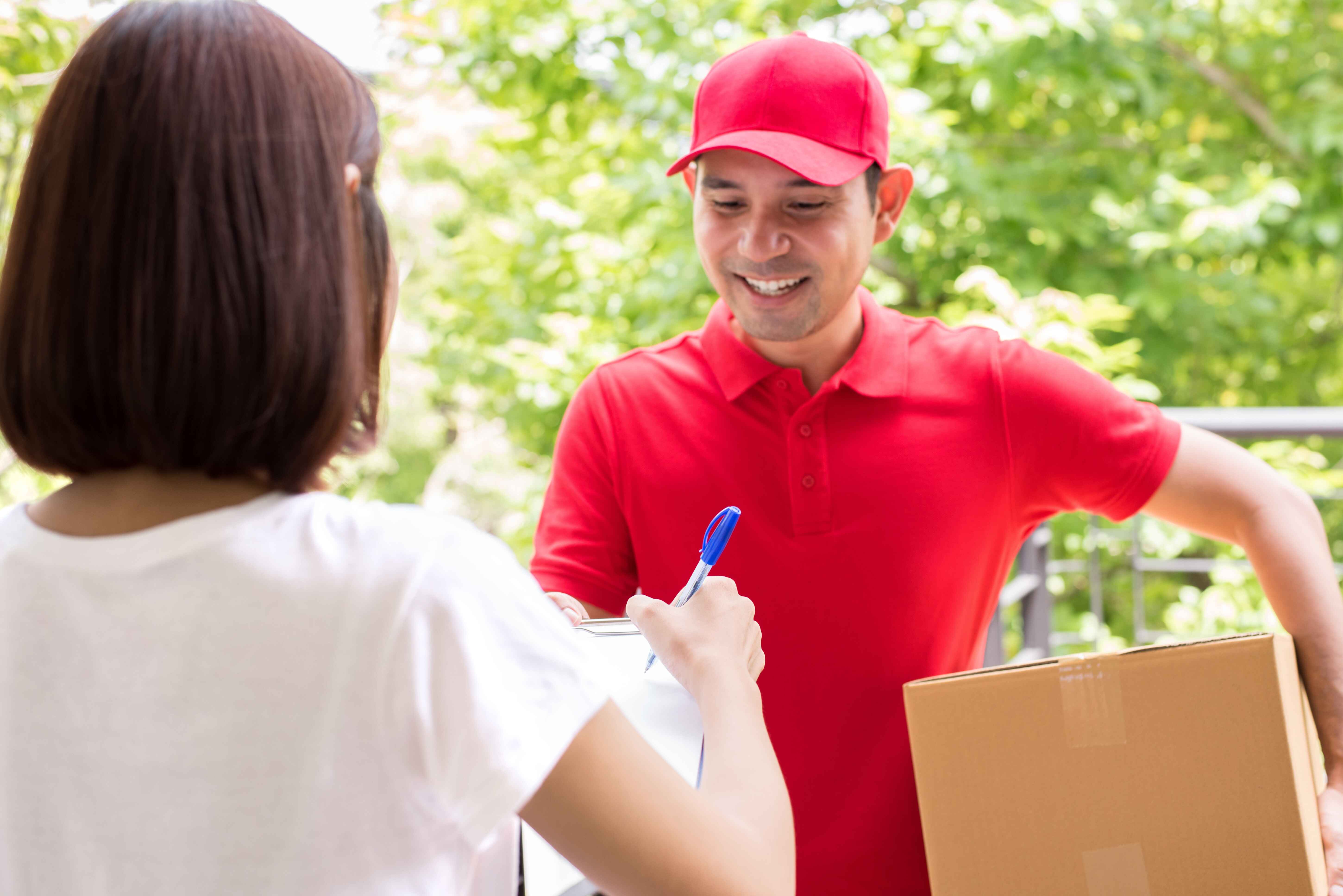 LBC delivery man handing package to customer